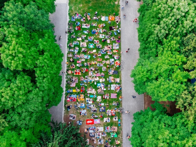 An aerial view of a community event setup in a public park with several tents, food trucks, and activity areas, highlighting the event layout and organization.