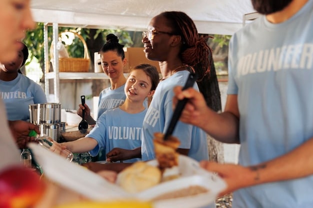 A diverse group of volunteers working together enthusiastically at a community event, wearing branded t-shirts with sponsor logos. The image showcases the community spirit and the positive impact of sponsor involvement.