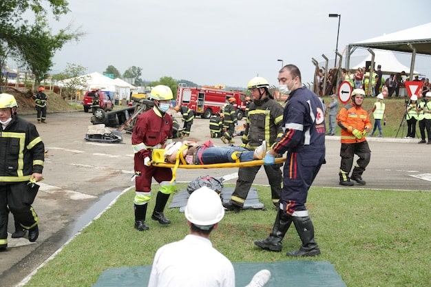 Event staff participating in an emergency response drill. The drill includes scenarios such as a medical emergency, a fire, and a security threat. The image shows staff members practicing their roles and responsibilities, using emergency equipment (e.g., first-aid kits, fire extinguishers), and communicating with each other effectively. The setting is a simulated event environment with realistic props and actors.