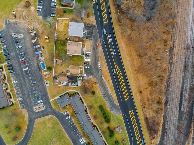 An aerial view of multiple construction sites showing different stages of infrastructure development, like roads, railways, and bridges, illustrating ongoing projects that depend on federal funding.