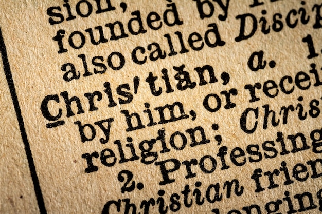 A close-up photograph of the Second Amendment text from the Bill of Rights, displayed in a historical document. The lighting highlights the aged parchment and intricate script.