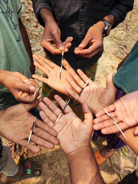 A close-up of a volunteer's hands working on a project for a community event, such as assembling care packages or setting up decorations. The blurred background shows other volunteers in action, emphasizing the collaborative aspect and reflecting How Will the Updated 2025 National Volunteer Tax Credit Impact Community Event Funding by boosting volunteer participation.