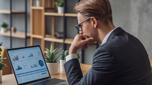 A businessman looking concerned over his laptop while analyzing a graph with a downward trend, illustrating the financial distress and the need for strategies to navigate the Small Business Bankruptcy Filings Surge 15% This Quarter.
