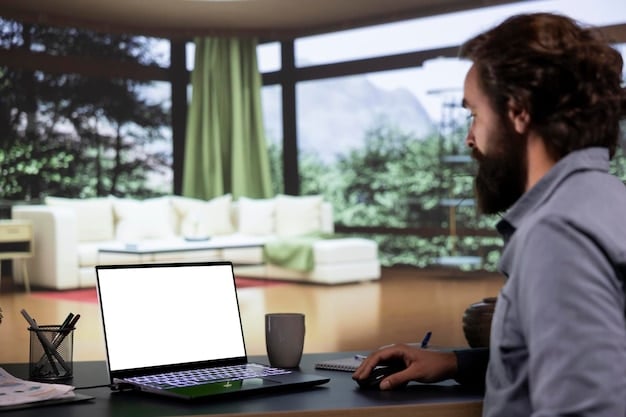 A person working on a laptop in a well-designed home office setup. The screen displays a dashboard with data analytics, charts, and graphs. The image conveys the use of technology to monitor and manage remote work performance. Aligns with Insider Report: How Fortune 500 Companies Are Adapting to the New Remote Work Landscape.