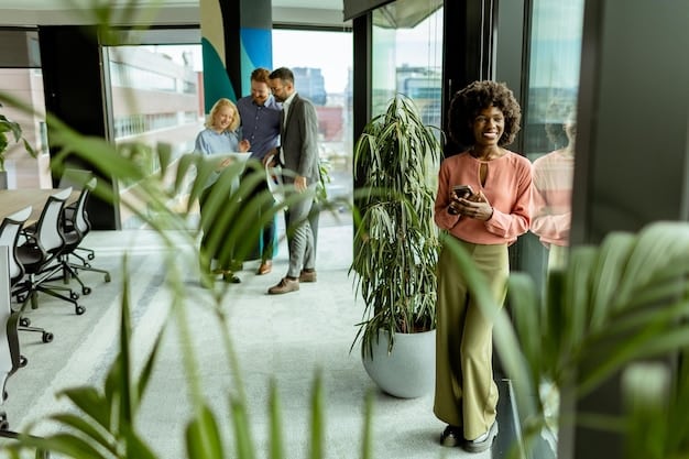 A professional business meeting taking place in a modern, eco-friendly office building where diverse professionals are discussing a green initiative project, with charts and graphs on a large screen displaying financial projections for sustainable investments.